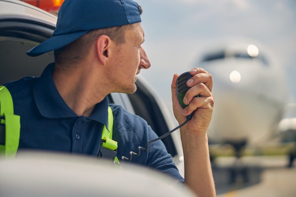 Airport car driver using a two-way radio